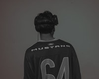 a man in a mustang jersey wearing headphones